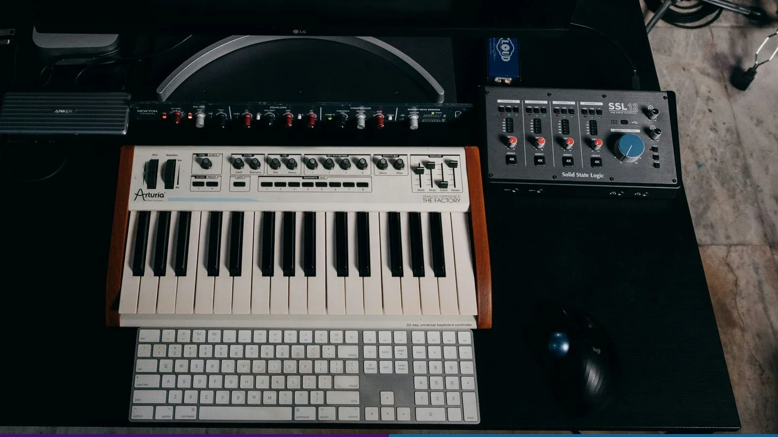 Controlador de teclado Arturia e interface SSL 12 em uma mesa de produção musical